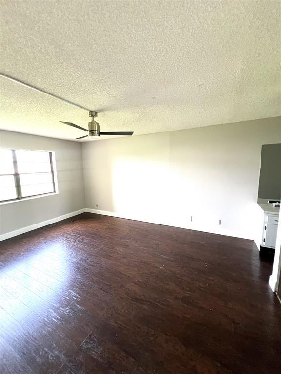 9273 Southwest 8th Street, Unit 216 Boca Raton, FL 33428 - Photo 5 of 7 an empty room with wooden floor and windows