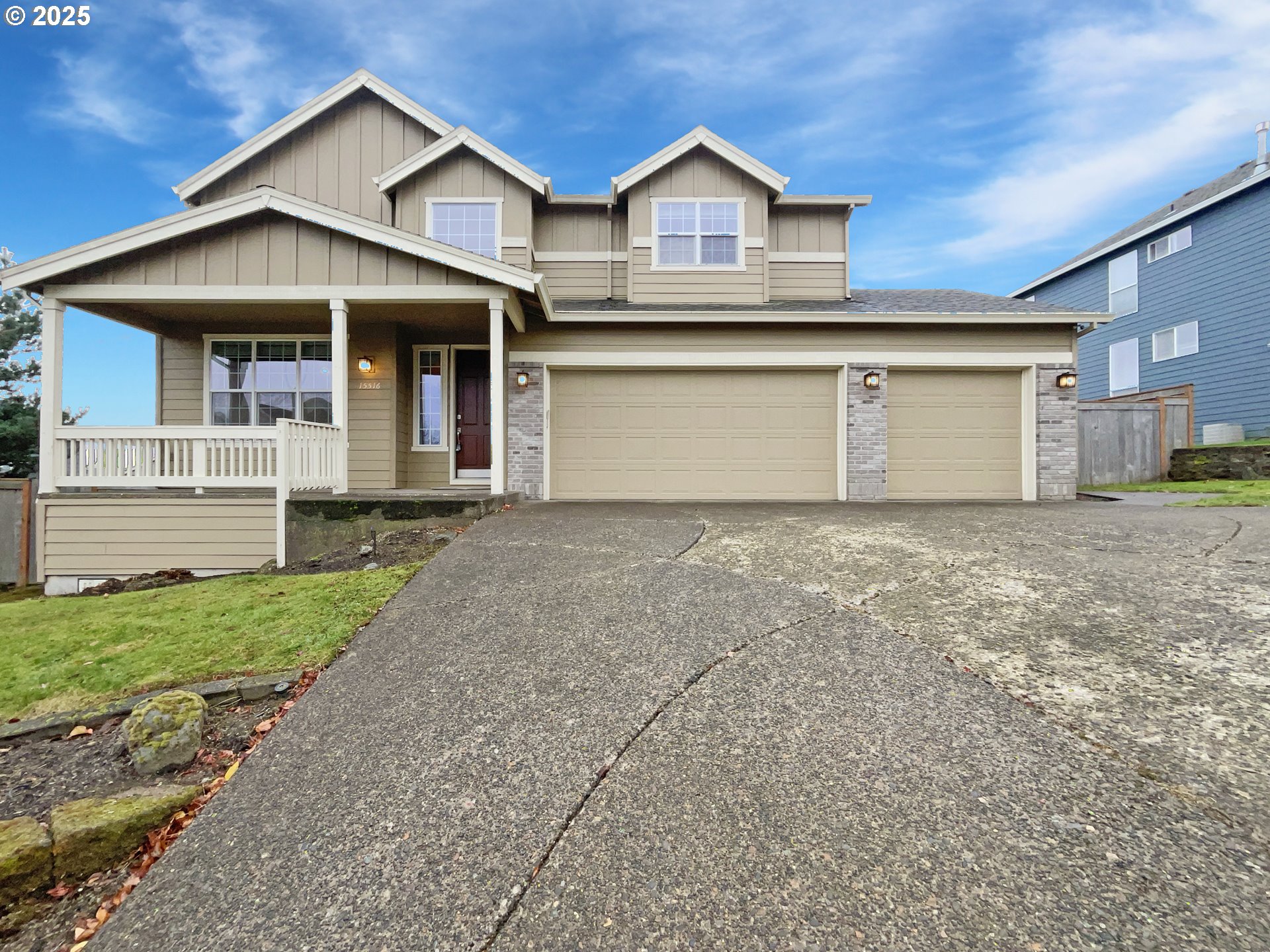 a front view of a house with a yard and garage