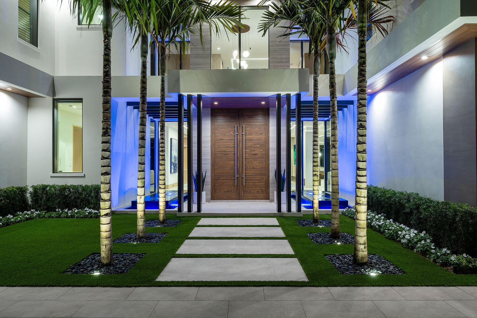 1520 Royal Palm Way Boca Raton, FL 33432 - Photo 77 of 100 a front view of a house with a garden and plants