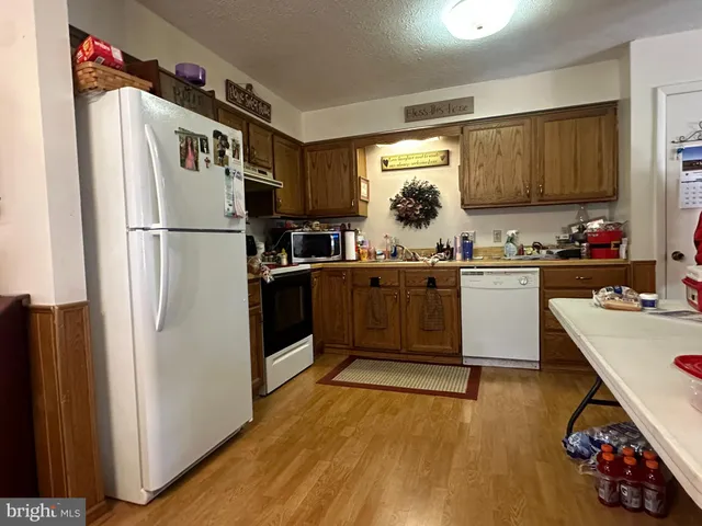 a kitchen with a sink appliances and cabinets