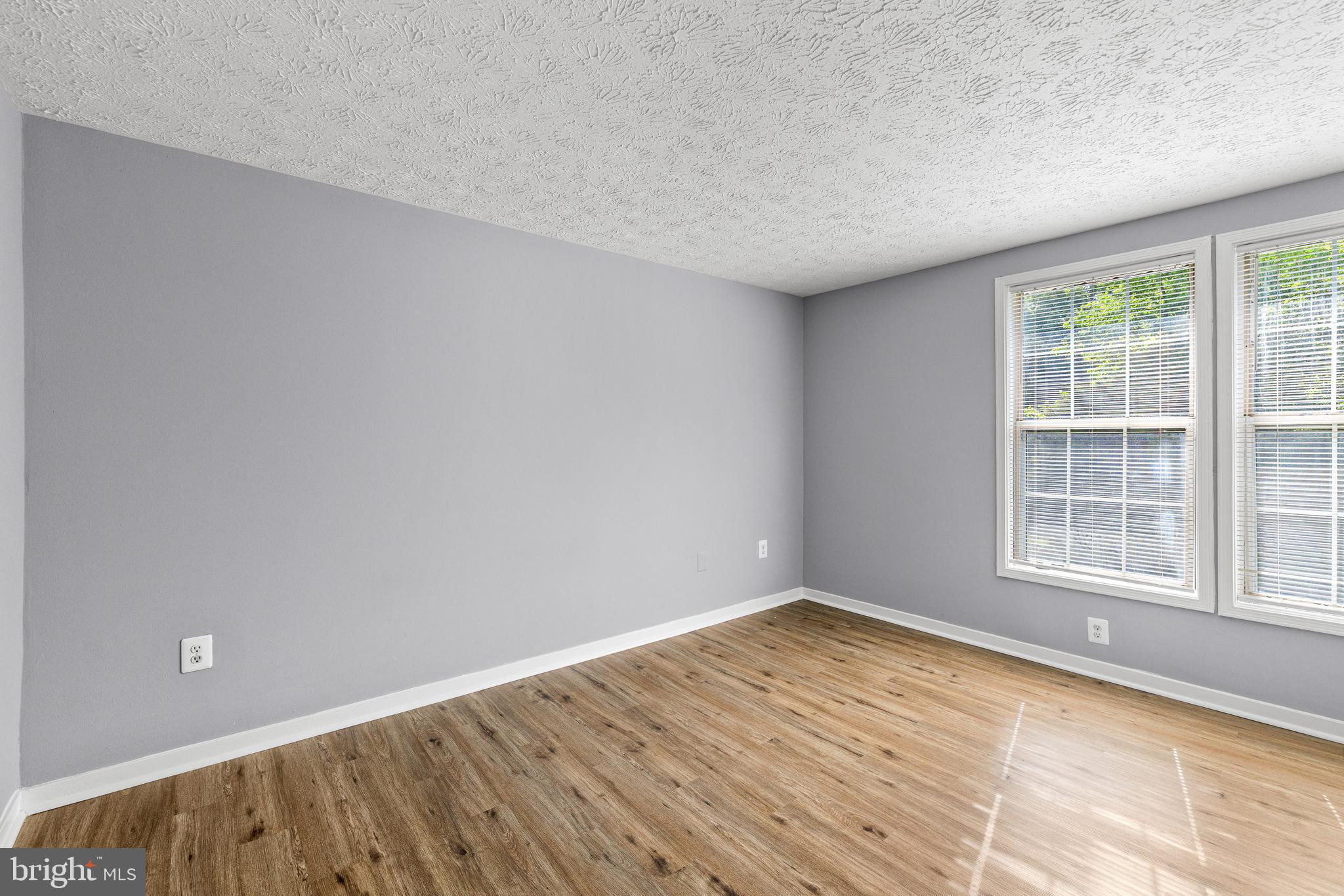9479 Inaugural Drive King George, VA 22485 - Photo 17 of 26 an empty room with wooden floor and windows