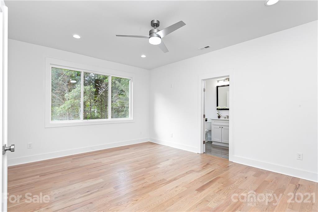 3909 Plainview Road Charlotte, NC 28208 - Photo 11 of 24 wooden floor in an empty room with a window