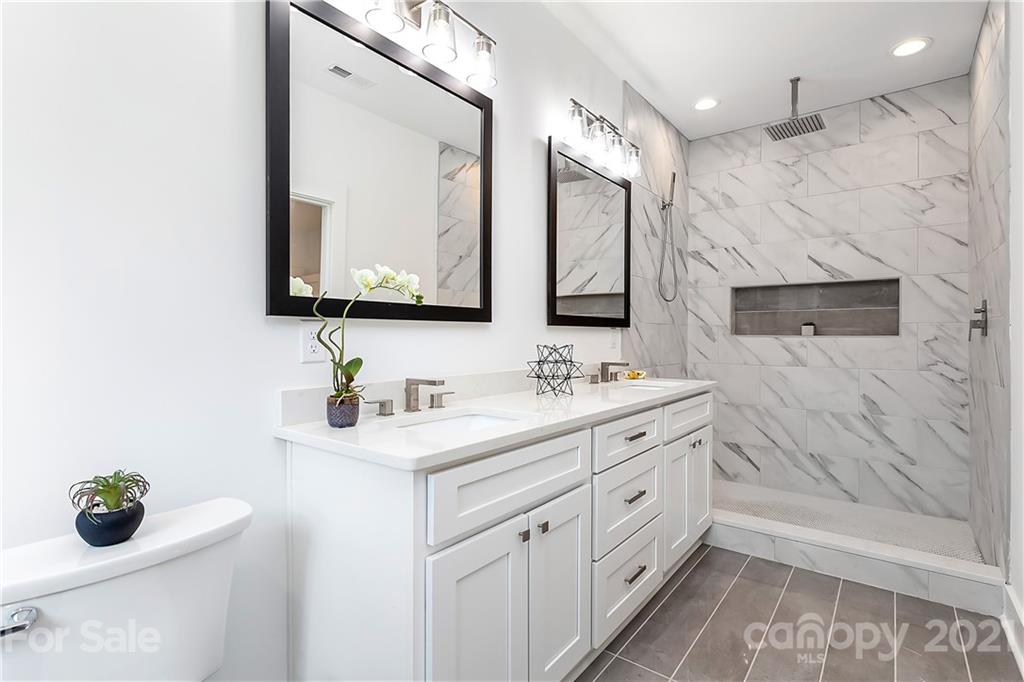 3909 Plainview Road Charlotte, NC 28208 - Photo 14 of 24 a bathroom with a double vanity sink mirror and