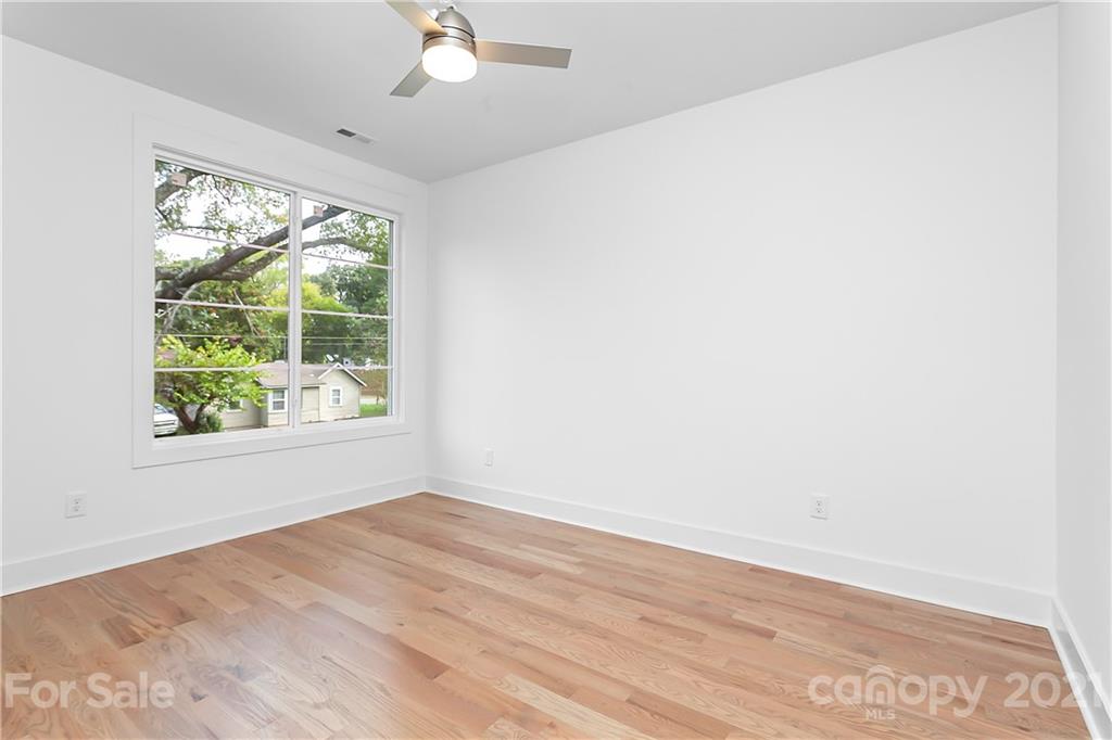 3909 Plainview Road Charlotte, NC 28208 - Photo 17 of 24 an empty room with wooden floor and windows