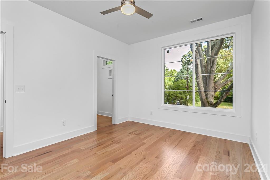 3909 Plainview Road Charlotte, NC 28208 - Photo 18 of 24 a view of an empty room with wooden floor and a window