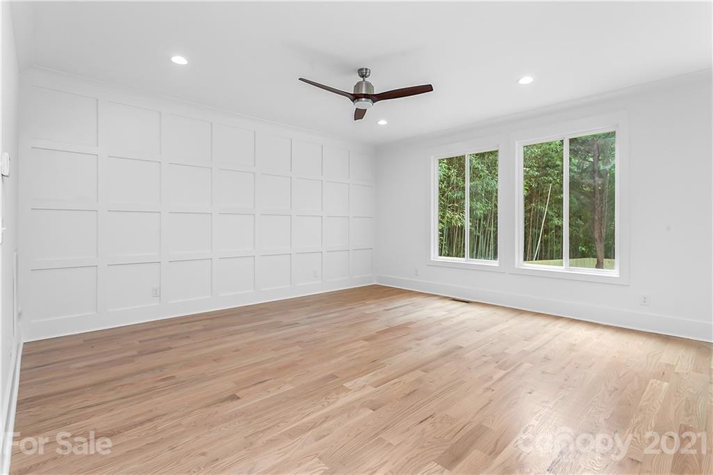 3909 Plainview Road Charlotte, NC 28208 - Photo 7 of 24 an empty room with wooden floor and windows