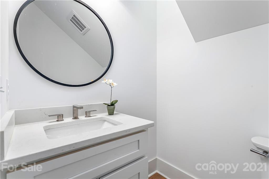 3909 Plainview Road Charlotte, NC 28208 - Photo 10 of 24 a bathroom with a sink a toilet and a mirror