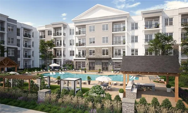 a view of a building with garden and sitting area