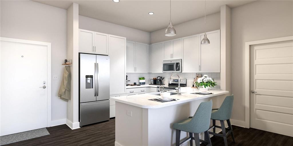 2600 Holcomb Bridge Road, Unit 2B Alpharetta, GA 30022 - Photo 14 of 21 a kitchen with a sink a refrigerator and white cabinets with wooden floor