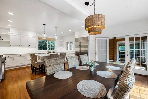 a dining room with furniture and wooden floor