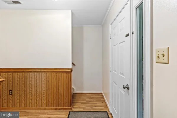a view of a hallway with wooden floor