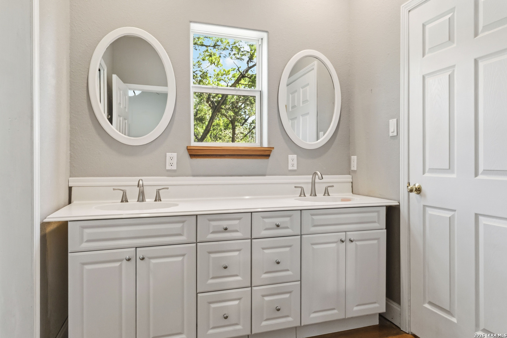 19708 Nottingham Lane Grey Forest, TX 78023 - Photo 34 of 67 a bathroom with 2 sink and a mirror