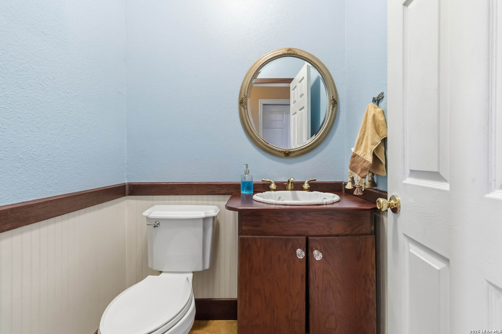 19708 Nottingham Lane Grey Forest, TX 78023 - Photo 40 of 67 a bathroom with a toilet a sink and a mirror