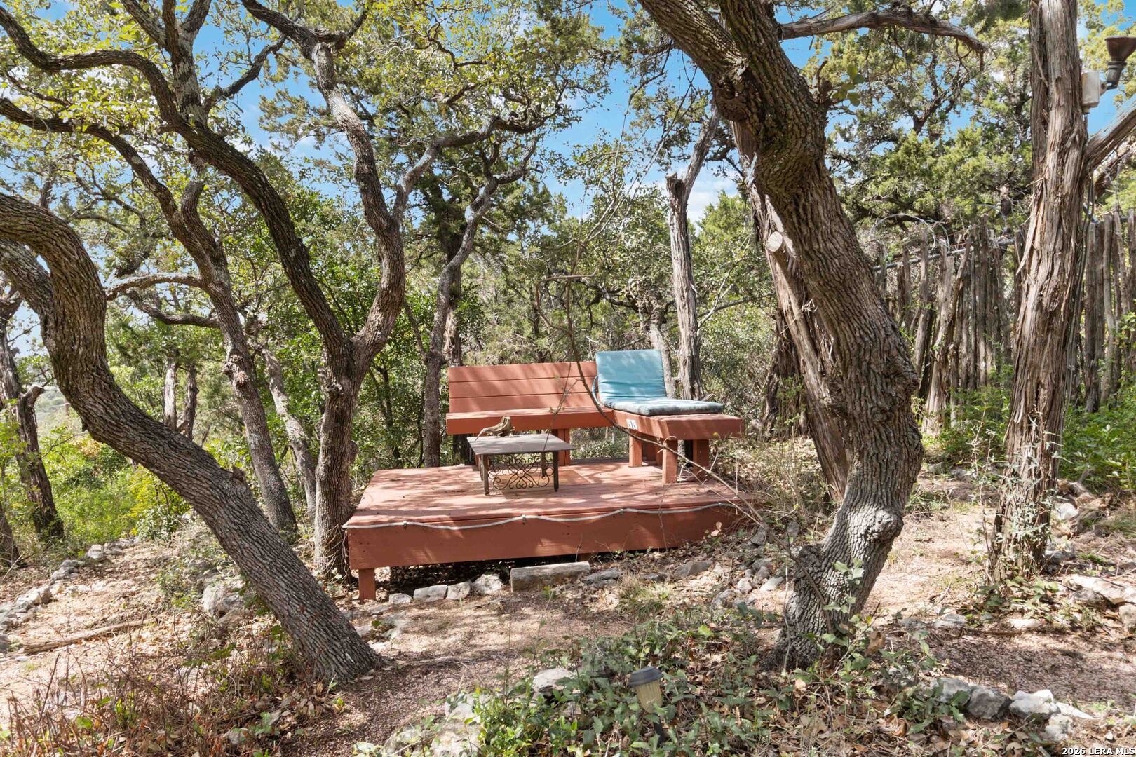 19708 Nottingham Lane Grey Forest, TX 78023 - Photo 49 of 67 a view of a backyard with table and chairs and a large tree