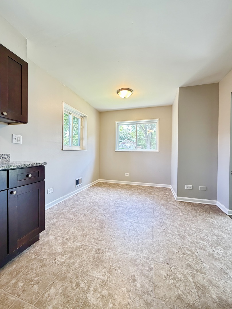 1820 169th Street Hazel Crest, IL 60429 - Photo 8 of 23 a view of an empty room with a window and a kitchen