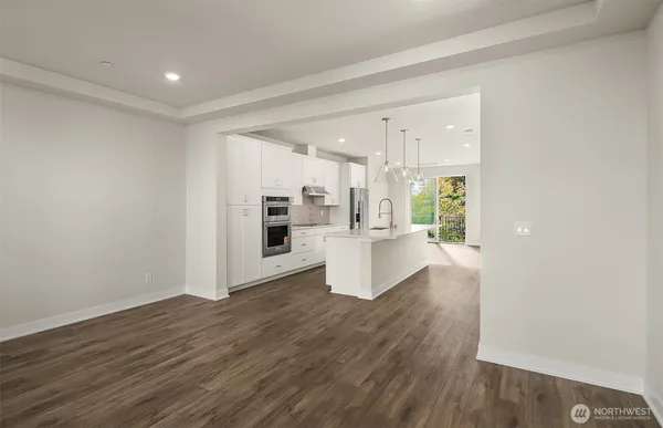 a view of kitchen and hall with wooden floor