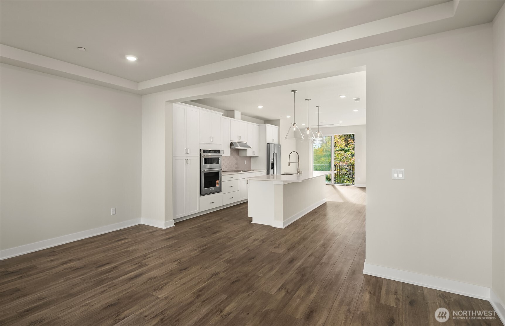 1004 243rd Place Southeast, Unit B Bothell, WA 98021 - Photo 6 of 18 a view of kitchen and hall with wooden floor