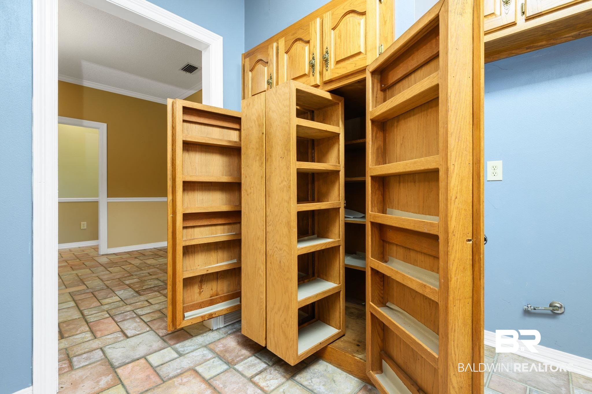 7540 2 Mile Road Irvington, AL 36544 - Photo 46 of 82 Built-in pantry cabinetry with multiple shelving units