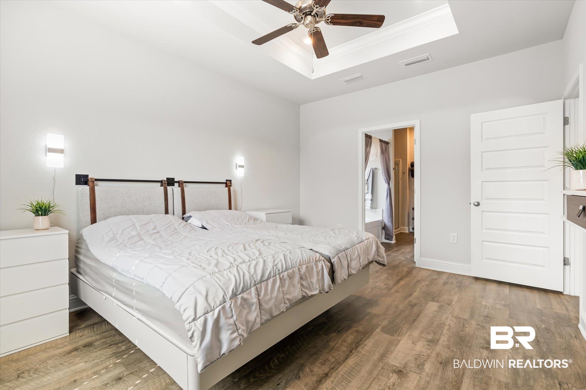 23246 Lieutenant Avenue Foley, AL 36535 - Photo 17 of 36 Bedroom featuring ensuite bathroom, dark hardwood / wood-style flooring, ceiling fan, a raised ceiling, and crown molding