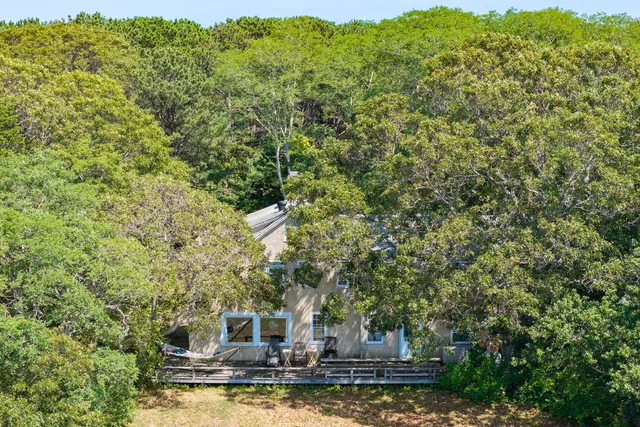 a kitchen with stainless steel appliances granite countertop a stove a sink dishwasher and white cabinets with wooden floor