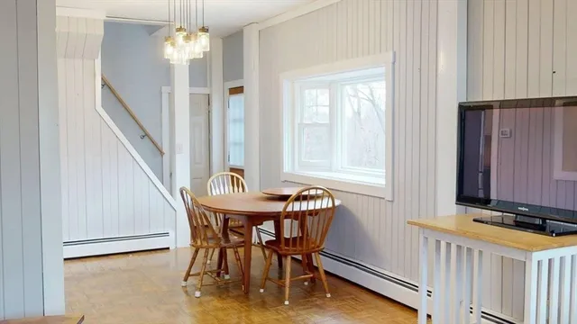 a dining room with furniture and window