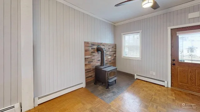 wooden floor and chair in a room with a window