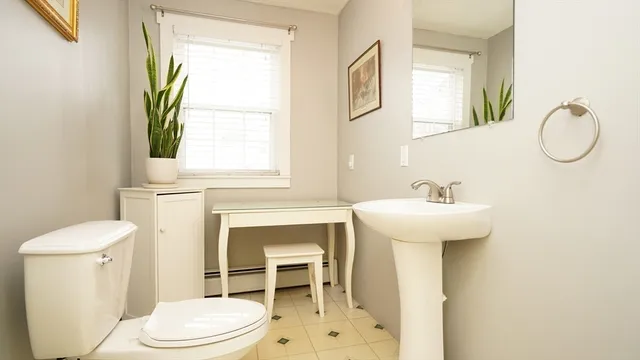 a bathroom with a sink toilet and a mirror