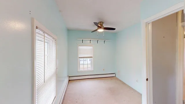 a view of room with a ceiling fan and window