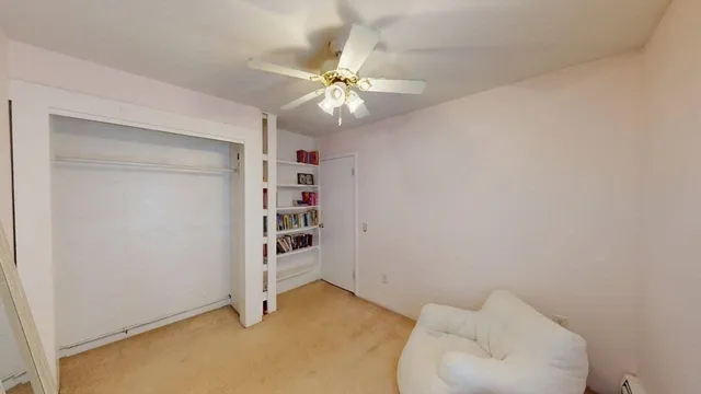 a view of an empty room with a ceiling fan