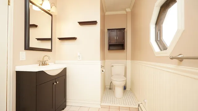 a bathroom with a sink a toilet and a mirror