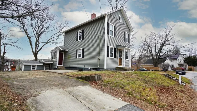 a view of a house with a yard covered in snow