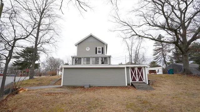 a view of a house with a yard covered in snow