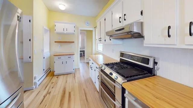 a kitchen with stainless steel appliances granite countertop a stove and a refrigerator
