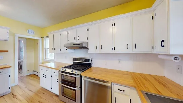 a kitchen with stainless steel appliances a white cabinets and a sink