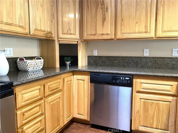 a kitchen with stainless steel appliances granite countertop a sink and a granite counter tops