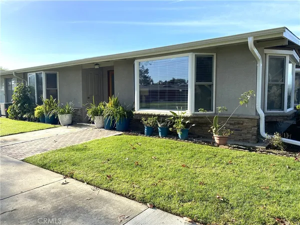 a view of a house with backyard and porch