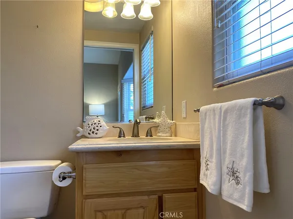 a bathroom with a sink vanity mirror and toilet