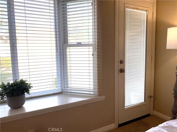 a view of a room that has a window and chair