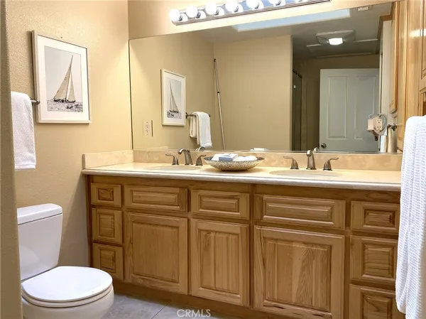 a bathroom with a sink a toilet and mirror