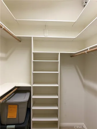 a view of walk in closet with empty racks