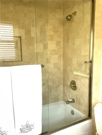 a bathroom with a bath tub and shower