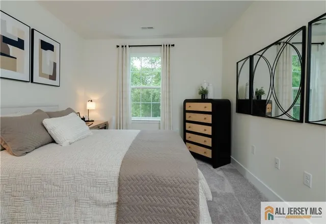 a bedroom with a bed next to a window