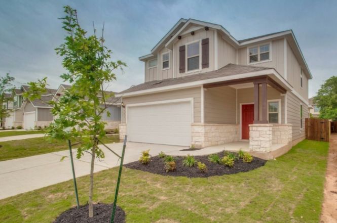 148 Spotted Rail Ridge Leander, TX 78641 - Photo 2 of 31 A welcoming facade with a stone-clad porch and attached garage.