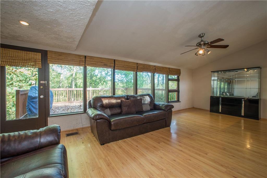 39 Buckhill Road Pittsburgh, PA 15237 - Photo 14 of 25 The window lined wall in the living room opens up to the large deck.