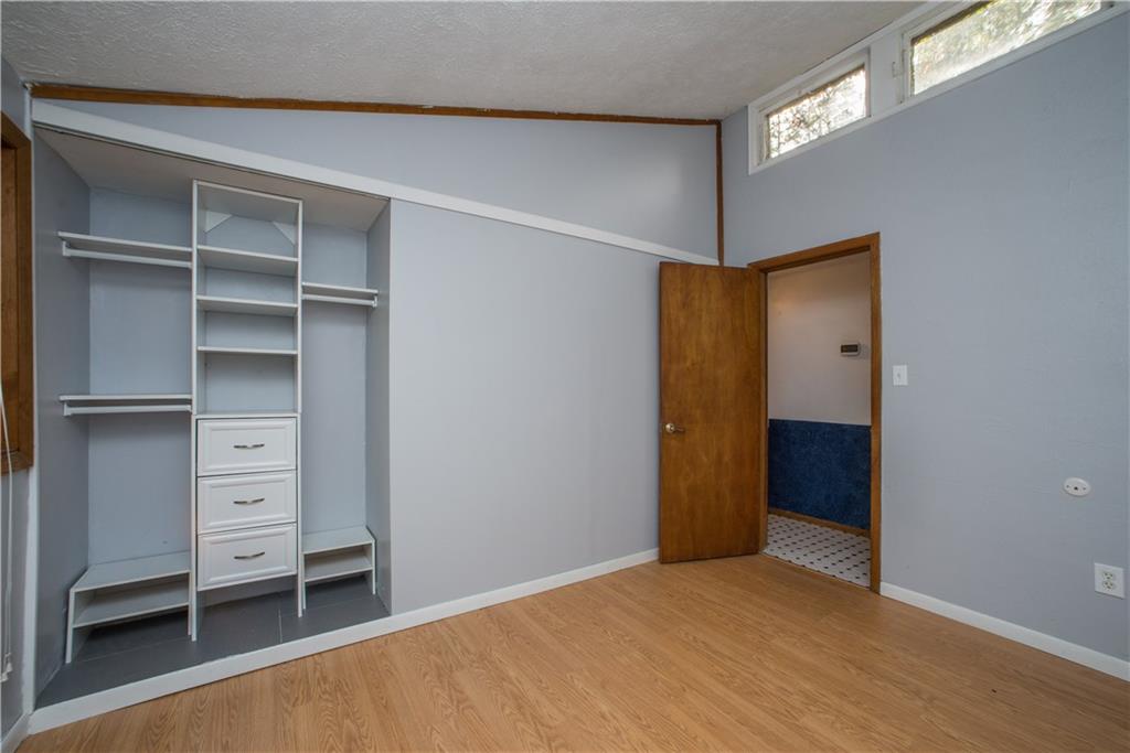 39 Buckhill Road Pittsburgh, PA 15237 - Photo 20 of 25 The bedroom includes a closet organizer and hardwood floors.