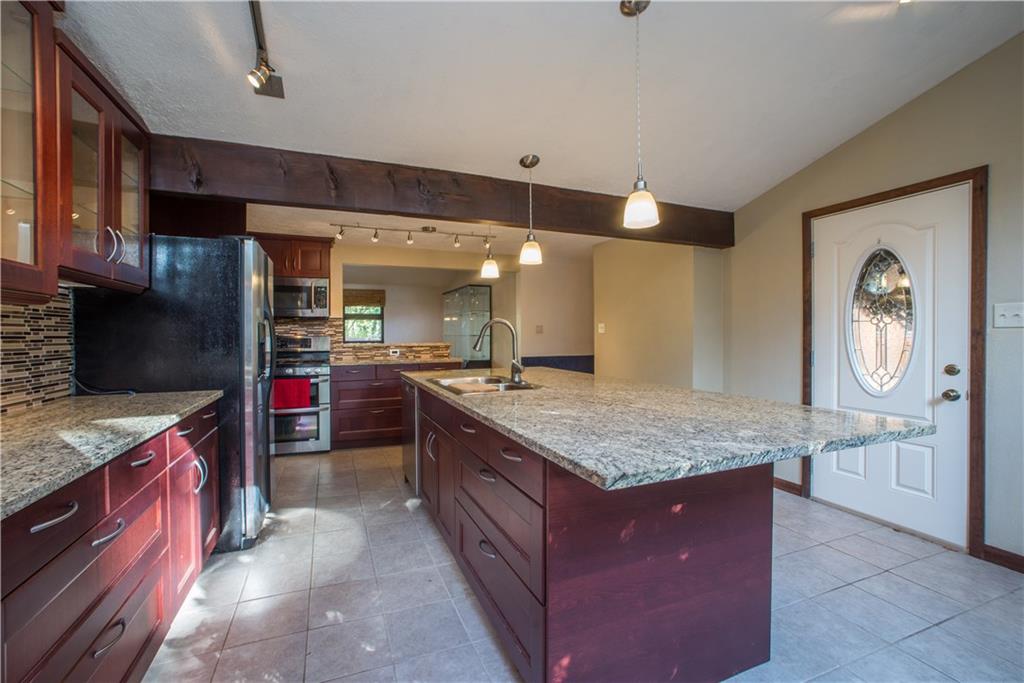 39 Buckhill Road Pittsburgh, PA 15237 - Photo 9 of 25 Enjoy granite countertops and glass tiled backsplash.