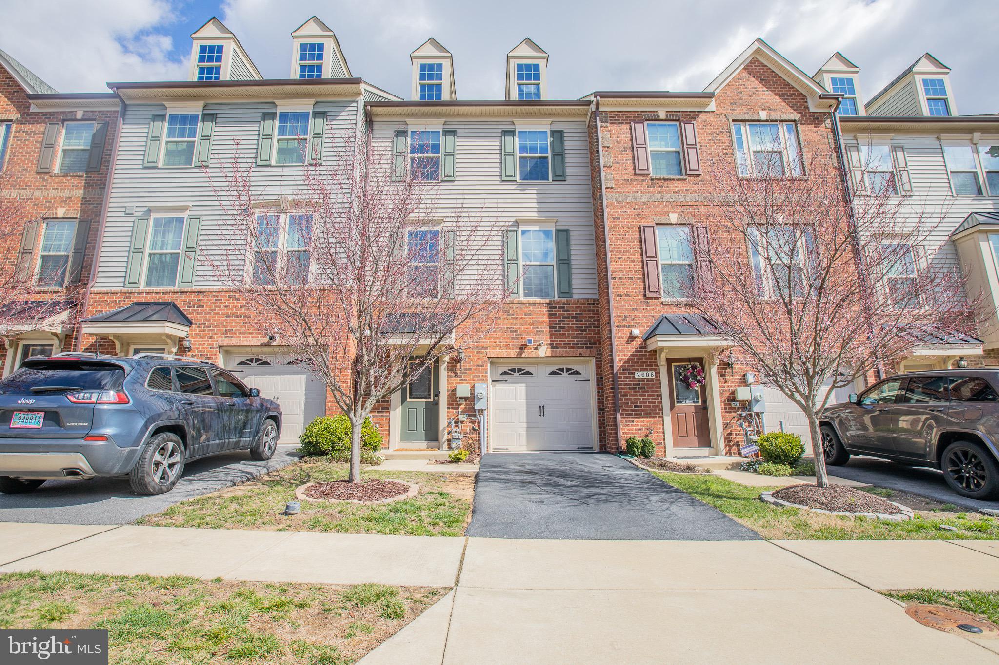 a front view of a residential apartment building with a yard