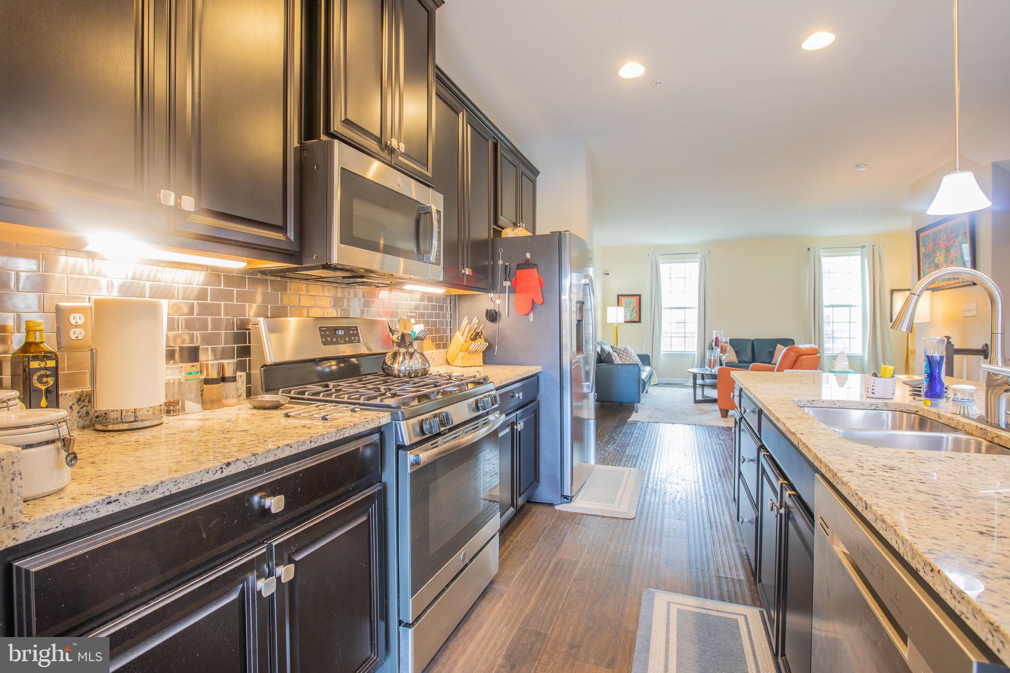 2608 Fiat Drive Hanover, MD 21076 - Photo 12 of 39 a kitchen with stainless steel appliances granite countertop a sink stove and refrigerator