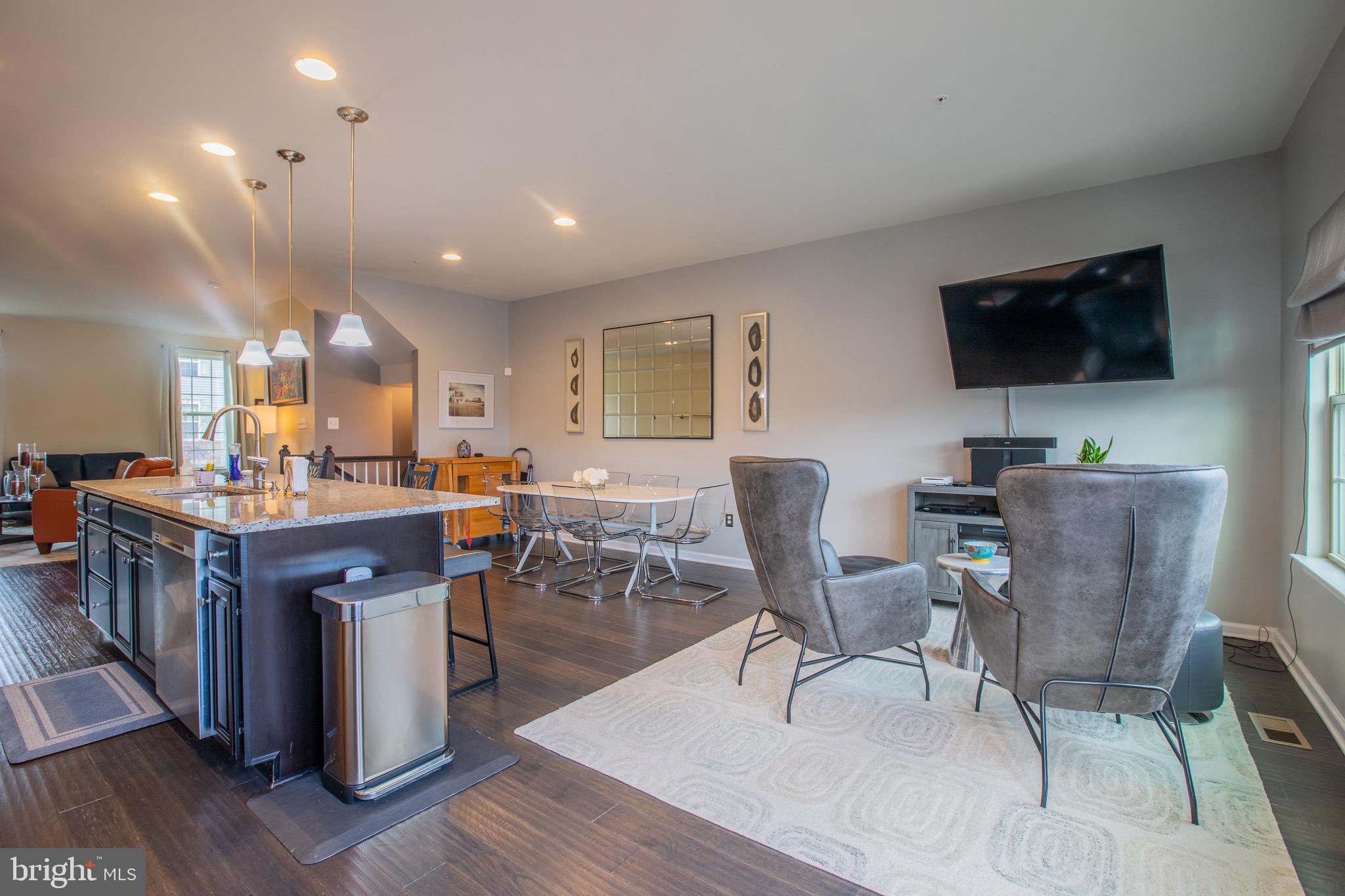 2608 Fiat Drive Hanover, MD 21076 - Photo 15 of 39 a living room with furniture a flat screen tv and kitchen view