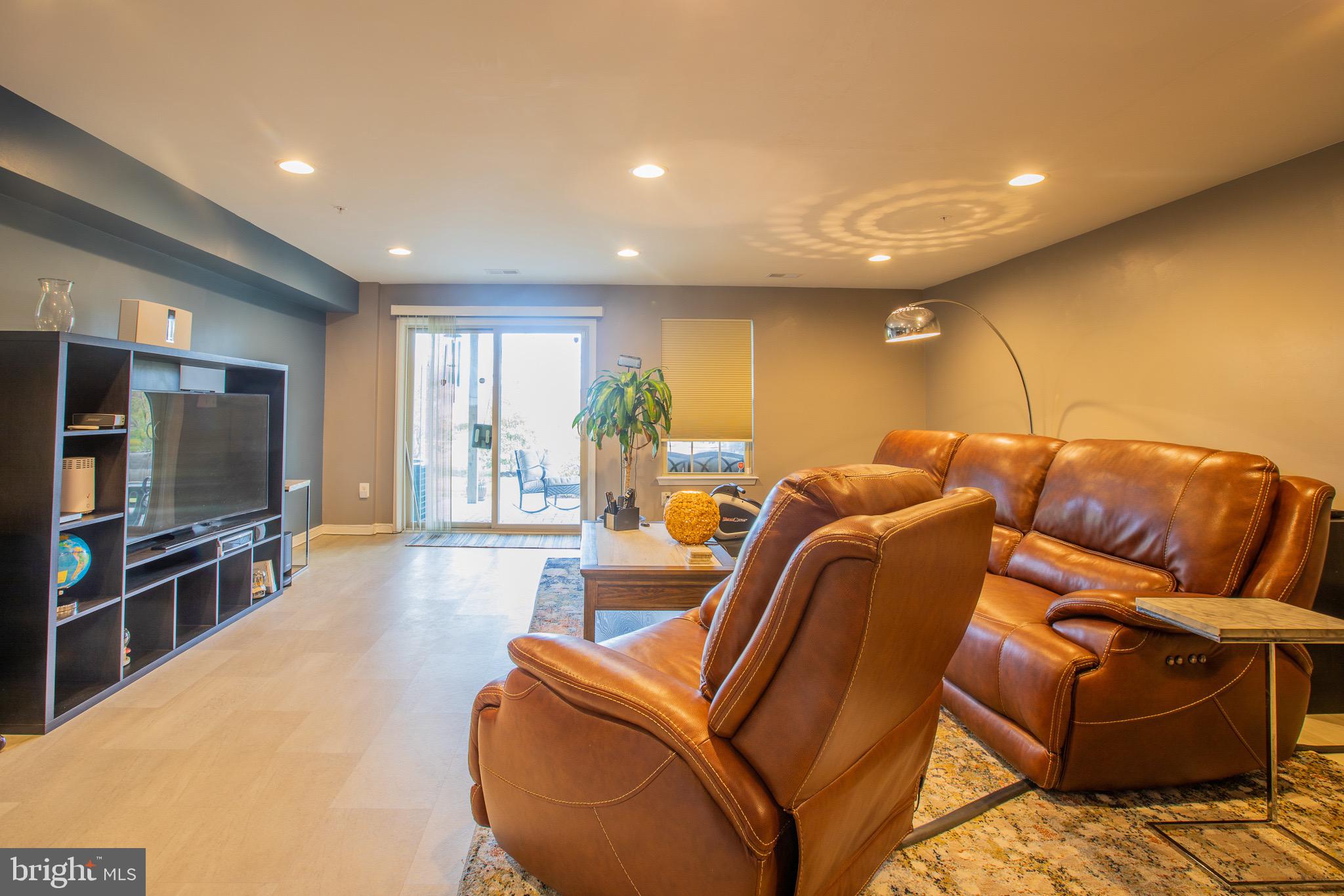 2608 Fiat Drive Hanover, MD 21076 - Photo 6 of 39 a media room with lots of chairs and a projector screen